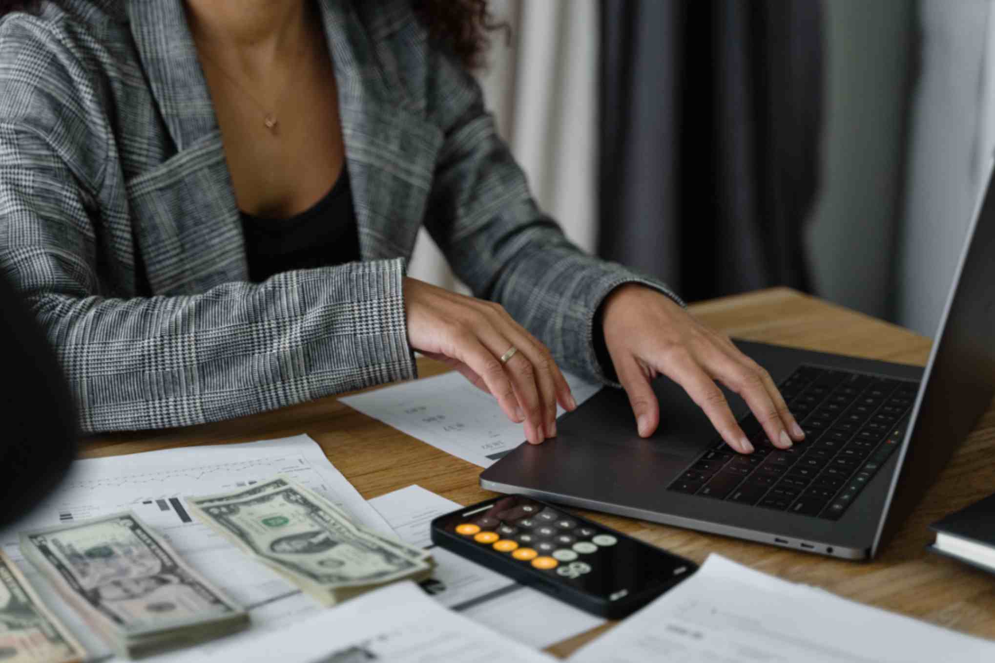 person checking finances on laptop, Money UK